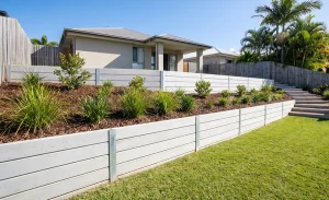 Concrete sleeper retaining wall creating a level garden terrace on a sloping Gold Coast backyard.